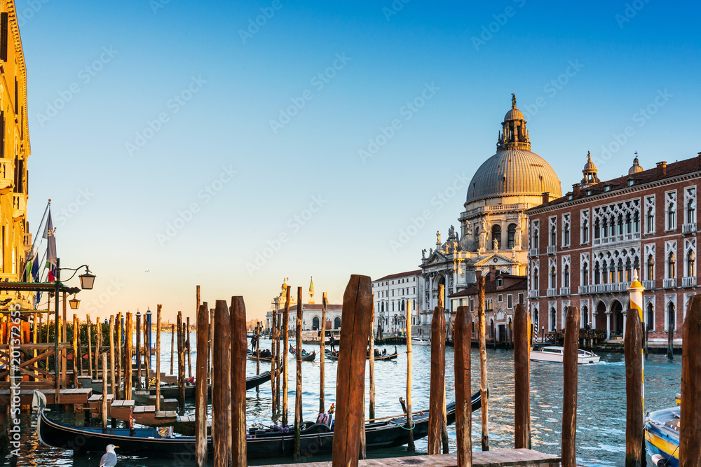 VENICE,ITALY- December 21, 2017 : Tourists on water street with Gondola in Venice. its entirety is listed as a World Heritage Site, along with its lagoon