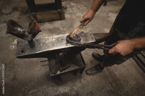 Low section of blacksmith working in workshop