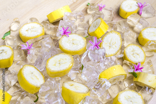 Pieces of ripe banana with peel on ice as a very icy refreshment