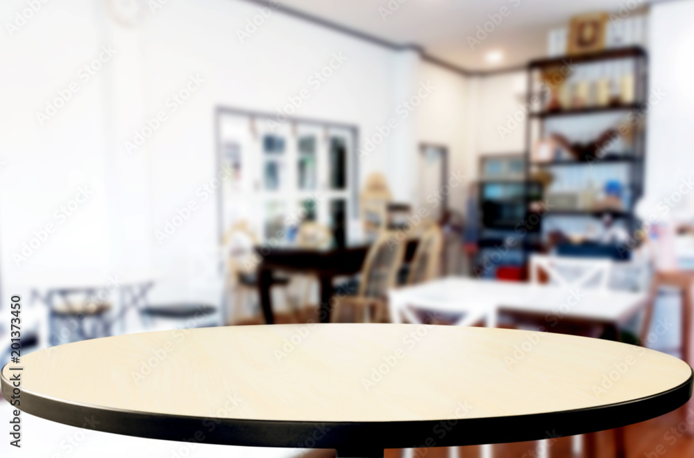 Selected focus empty brown wooden table and Coffee shop or restaurant blur background with bokeh image. for your photomontage or product display. Selected focus empty brown wooden table and Coffee shop or restaurant blur background with bokeh image. for your photomontage or product display.
