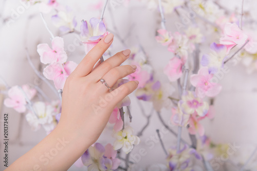 Woman's hands with jewelry rings. Close-up beauty and fashion portrait. Girl with pastel manicure. Jewelry and luxury concept. Beautiful woman with stylish accessories