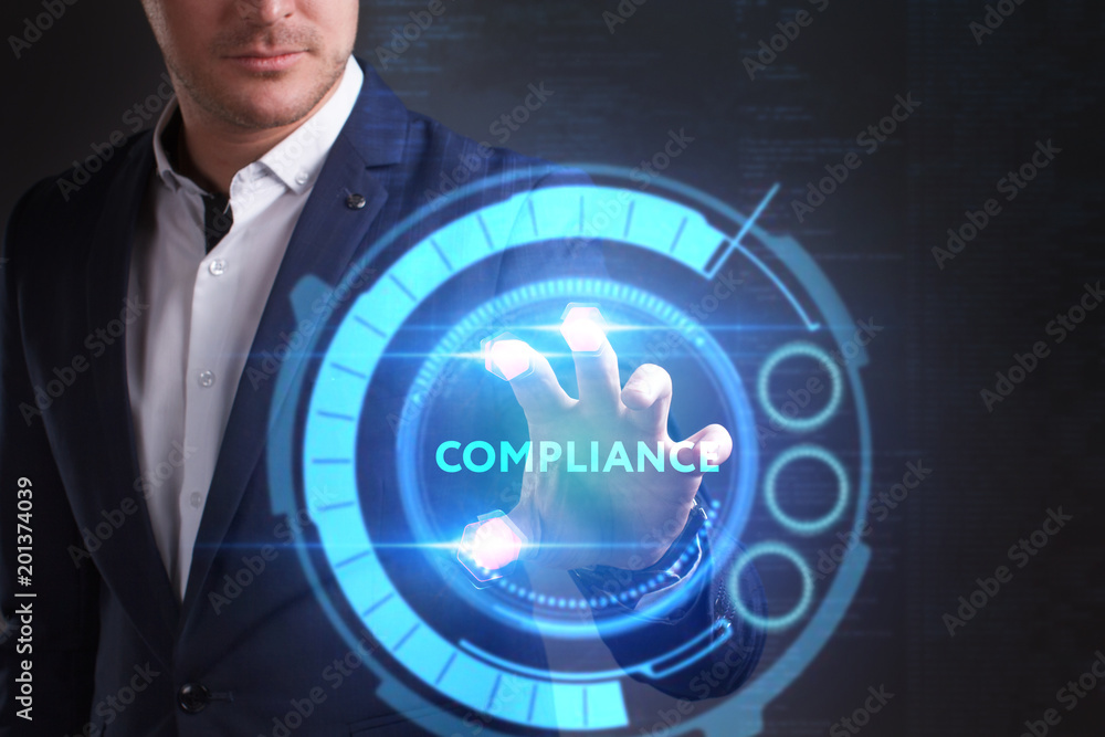Business, Technology, Internet and network concept. Young businessman working on a virtual screen of the future and sees the inscription: Compliance Business, Technology, Internet and network concept. Young businessman working on a virtual screen of the future and sees the inscription: Compliance