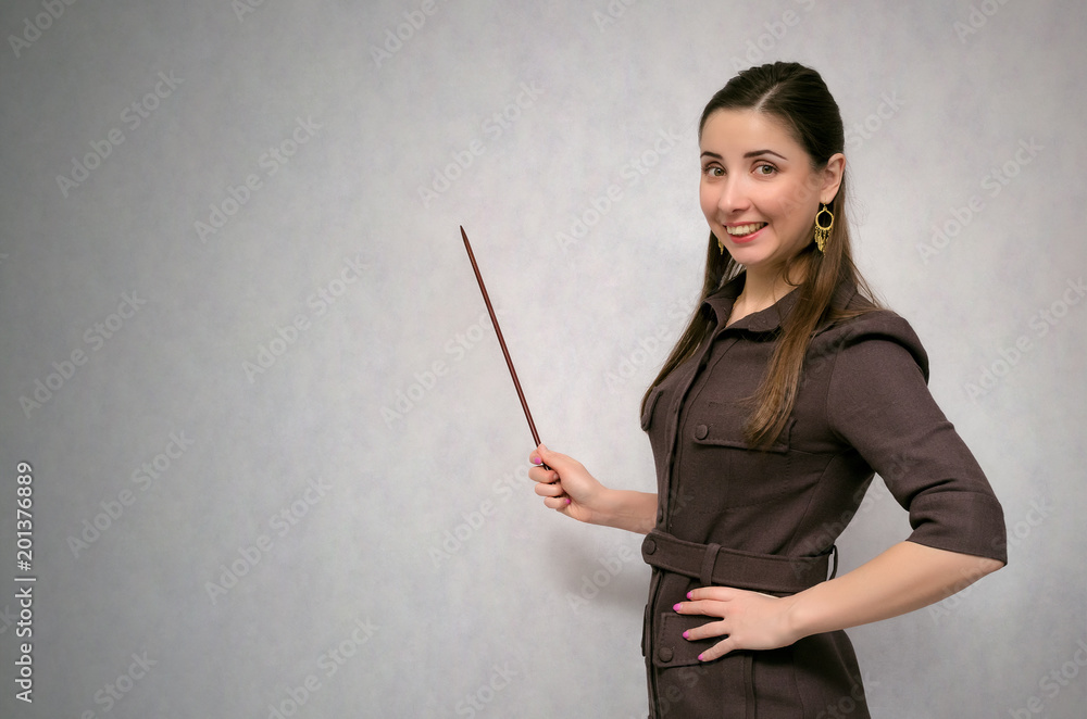 Business project presentation. Teacher or financial advisor or student with school pointer explains lesson theme isolated on gray background with copy space. Business project presentation. Teacher or financial advisor or student with school pointer explains lesson theme isolated on gray background with copy space.