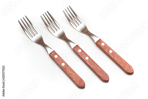 Fototapeta Set of three forks with wooden handles on white background