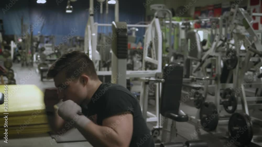 Young MMA fighter waits and then lunges into a three punch combo during a shadow boxing session Young MMA fighter waits and then lunges into a three punch combo during a shadow boxing session