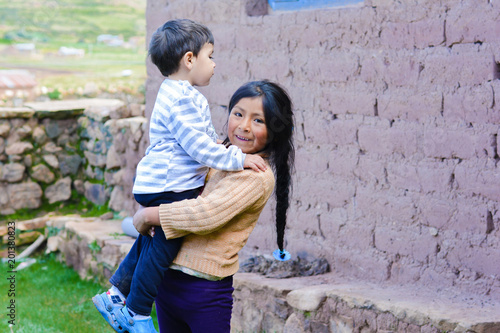Fotografie Native american girl holdiittle brother outside.