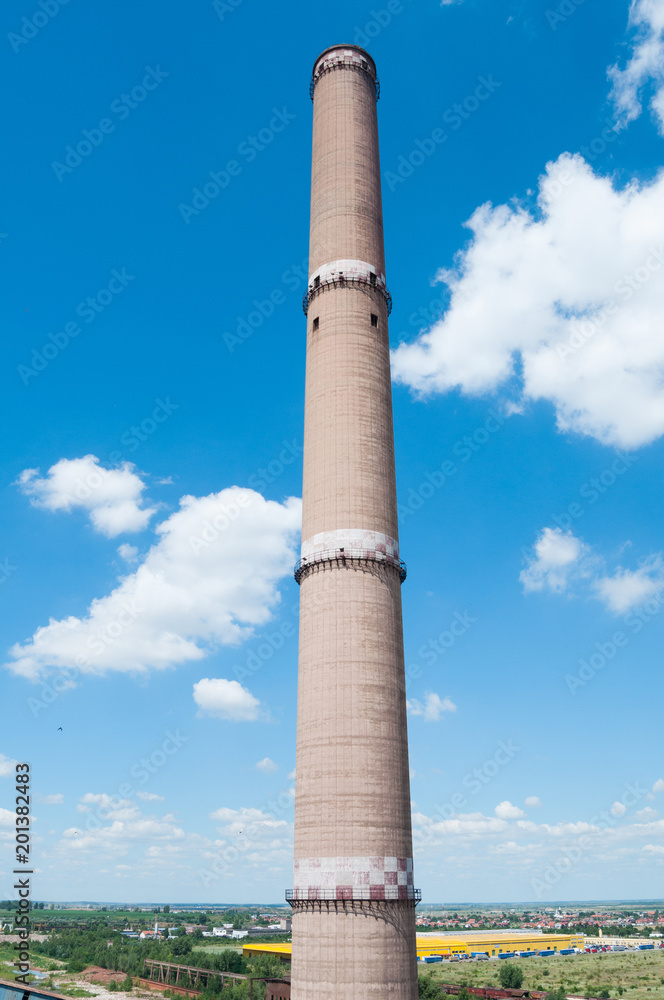 Industrial chimney with blue sky background