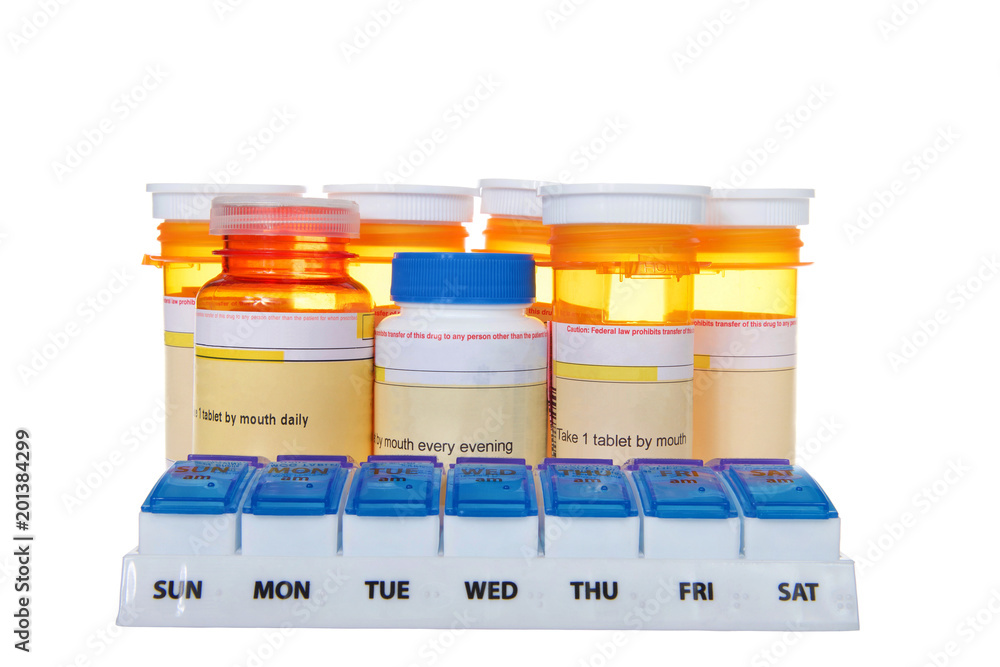 Twice daily medication organizer with many bottles of pills stacked