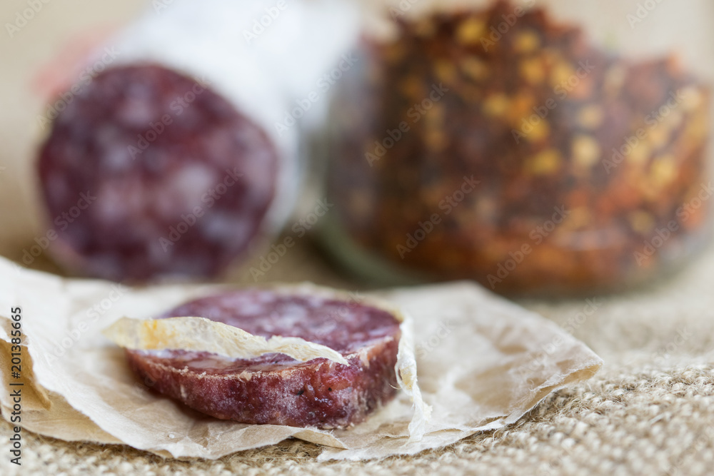 slice of hot salami with crushed hot pepper slice of hot salami with crushed hot pepper