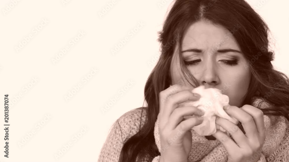 Sick freezing woman sneezing in tissue. Girl wearing warm sweater being cold and trembling. Flu or other virus. Health care. Sick freezing woman sneezing in tissue. Girl wearing warm sweater being cold and trembling. Flu or other virus. Health care.