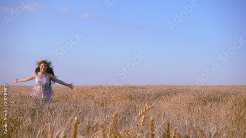 girl running on golden wheat field, slow motion
