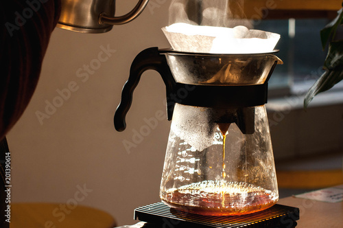 barista making alternative way of brewing coffee in the coffee shop hario v60 soft light
