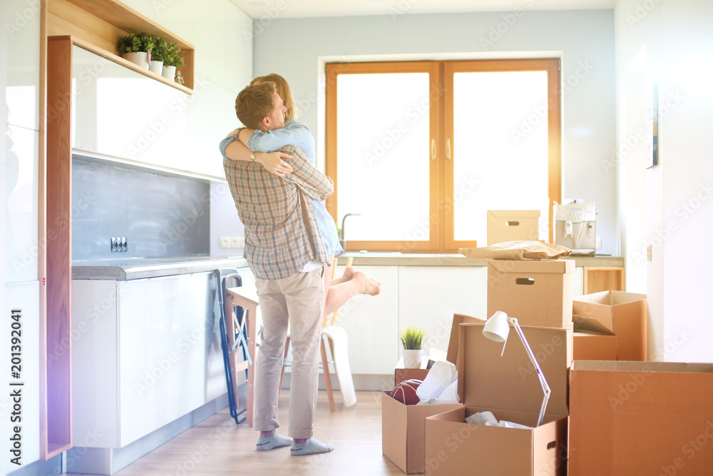 Portrait of young couple moving in new home. Young couple Portrait of young couple moving in new home. Young couple