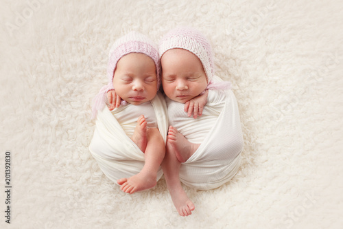 Newborn twin sisters sleep