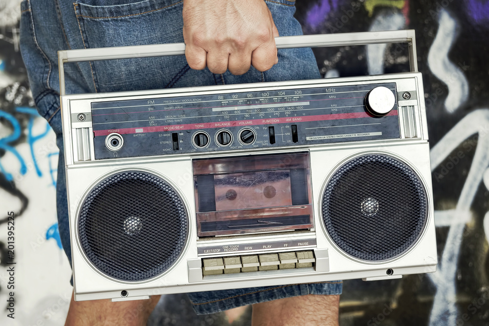 Fototapeta premium Person holding vintage boombox