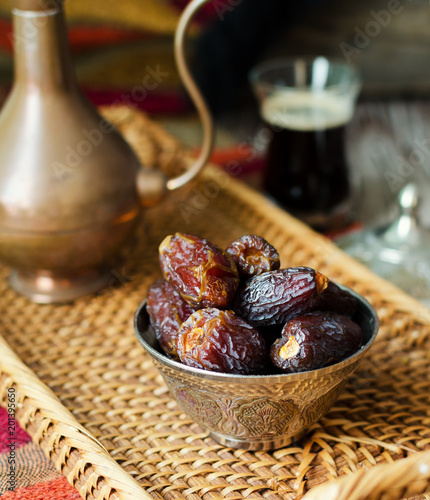 Eid mubarak with arabic coffee pot and dates. Dried dates and coffe