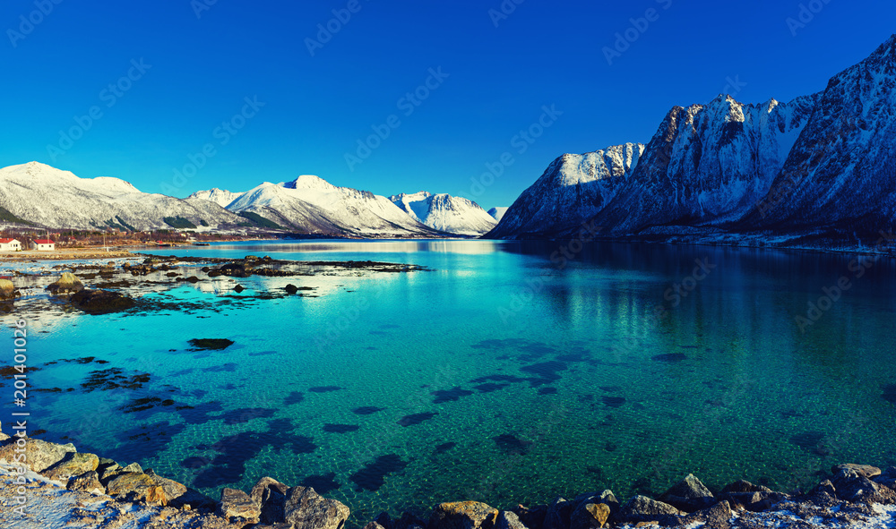 Naklejka premium Panoramic view of beautiful winter lake with snowy mountains at Lofoten Islands in Northern Norway