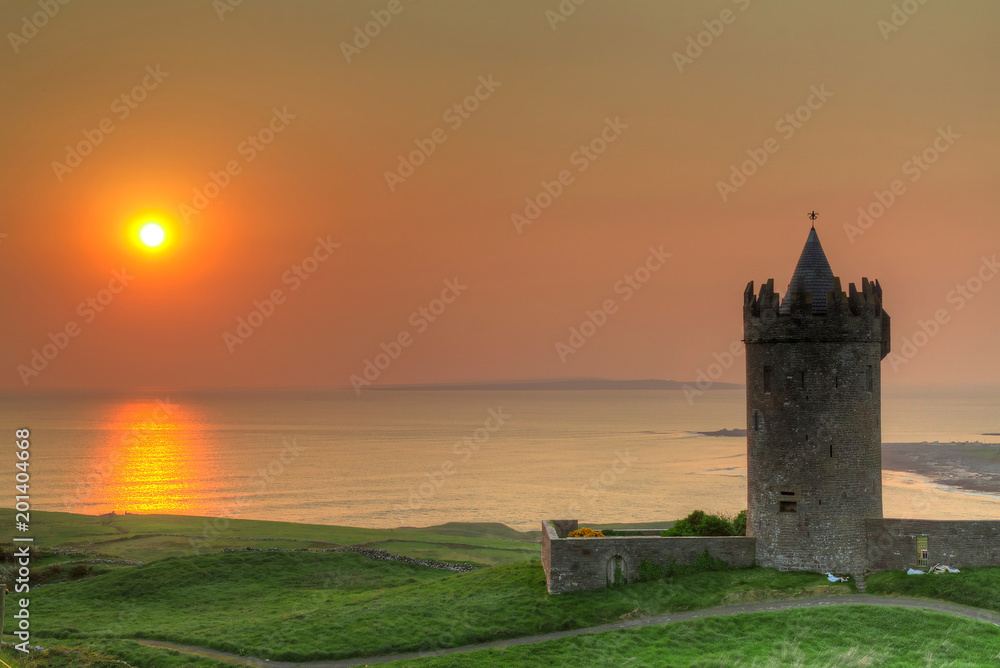 Doonegore castle at sunset in Doolin, Ireland Doonegore castle at sunset in Doolin, Ireland