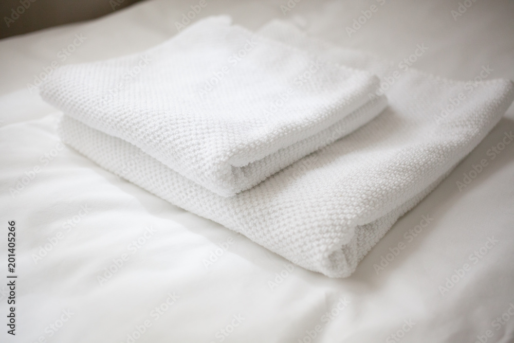 Two white towels on a white sheet Two white towels on a white sheet