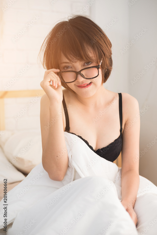 Fashion portrait of young elegant woman in bed Fashion portrait of young elegant woman in bed