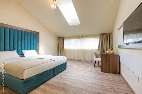 Interior of a double bed hotel bedroom in the morning