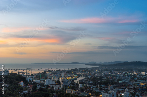 Beautiful aerial view from the high on Duong Dong town, sea, bay and hills at colorful sunset. Phu Quoc Island, Vietnam.