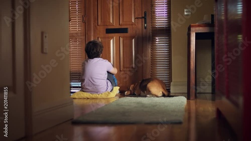 4k Dolly of House Front Door, Sad Dog and Child Waiting for Post photo