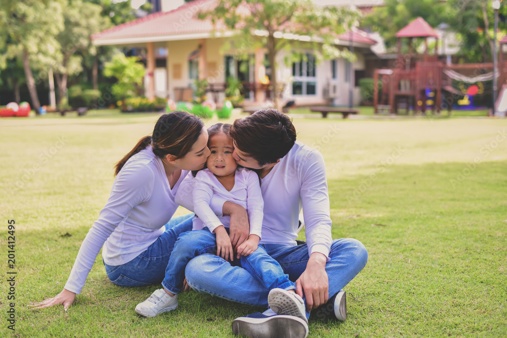 Happy male and female playing with children outside Happy male and female playing with children outside
