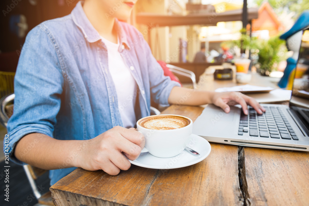 Beautiful hipster woman using laptop at cafe Beautiful hipster woman using laptop at cafe
