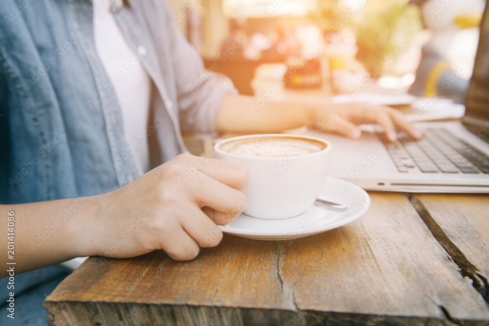 Beautiful hipster woman using laptop at cafe Beautiful hipster woman using laptop at cafe