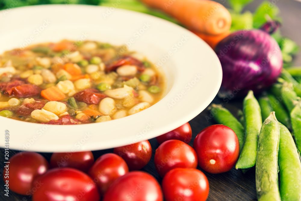 A close up of vegetable soup with tomatoes, carrots, celery, onions and other various vegetables A close up of vegetable soup with tomatoes, carrots, celery, onions and other various vegetables