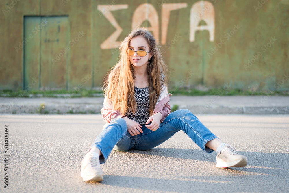 Young beautiful woman on the street. Emotions, people, beauty and lifestyle concept. Street photo of young woman wearing stylish casual clothes. Female fashion concept. Cute teenage girl. Young beautiful woman on the street. Emotions, people, beauty and lifestyle concept. Street photo of young woman wearing stylish casual clothes. Female fashion concept. Cute teenage girl.