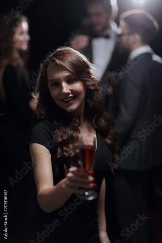 happy young woman raising glass in toast