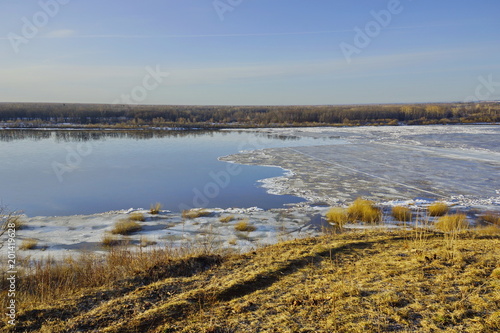 ice drift on the river. large ice floes floating on the water. spring is melting ice cracking. top view of the river