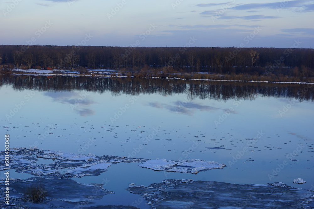 ice drift on the river. large ice floes floating on the water. spring is melting ice cracking. top view of the river