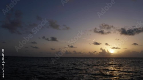 Rising sun on the horizon above a calm ocean