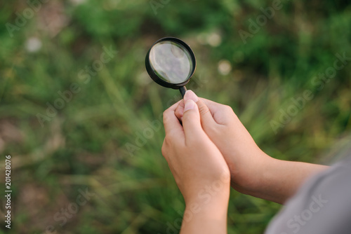 Magnifying glass in hand