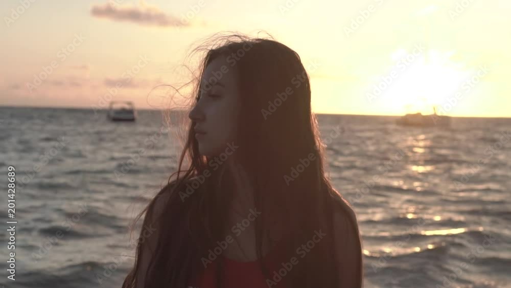 The silhouette of the girl on a background sunset The silhouette of the girl on a background sunset