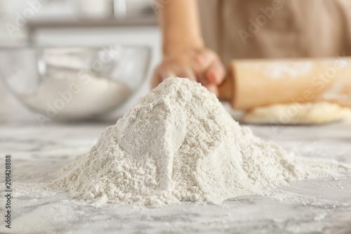 Pile of flour and woman on background