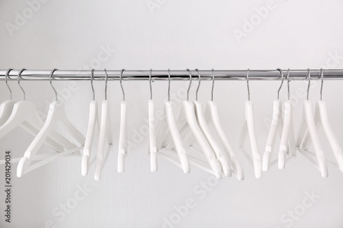 Clothes rail with hangers on white background