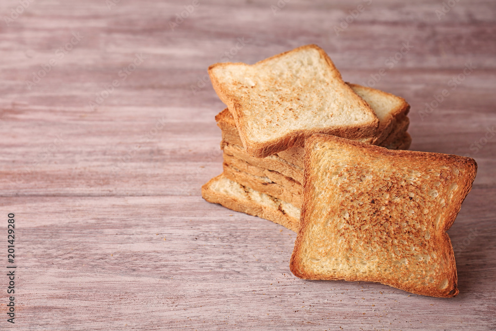 Tasty toasted bread on wooden background Tasty toasted bread on wooden background