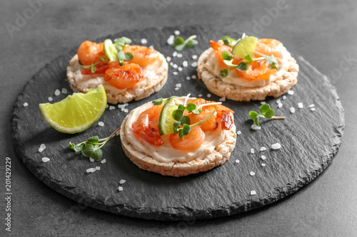 Delicious small sandwiches with shrimps on slate plate