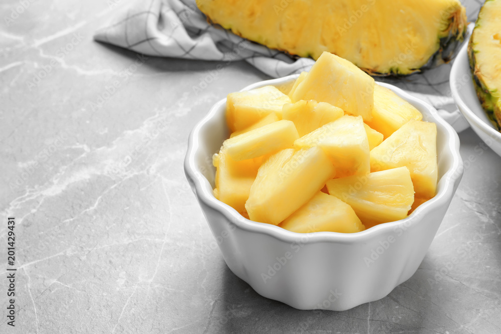 Bowl with fresh sliced pineapple on table Bowl with fresh sliced pineapple on table