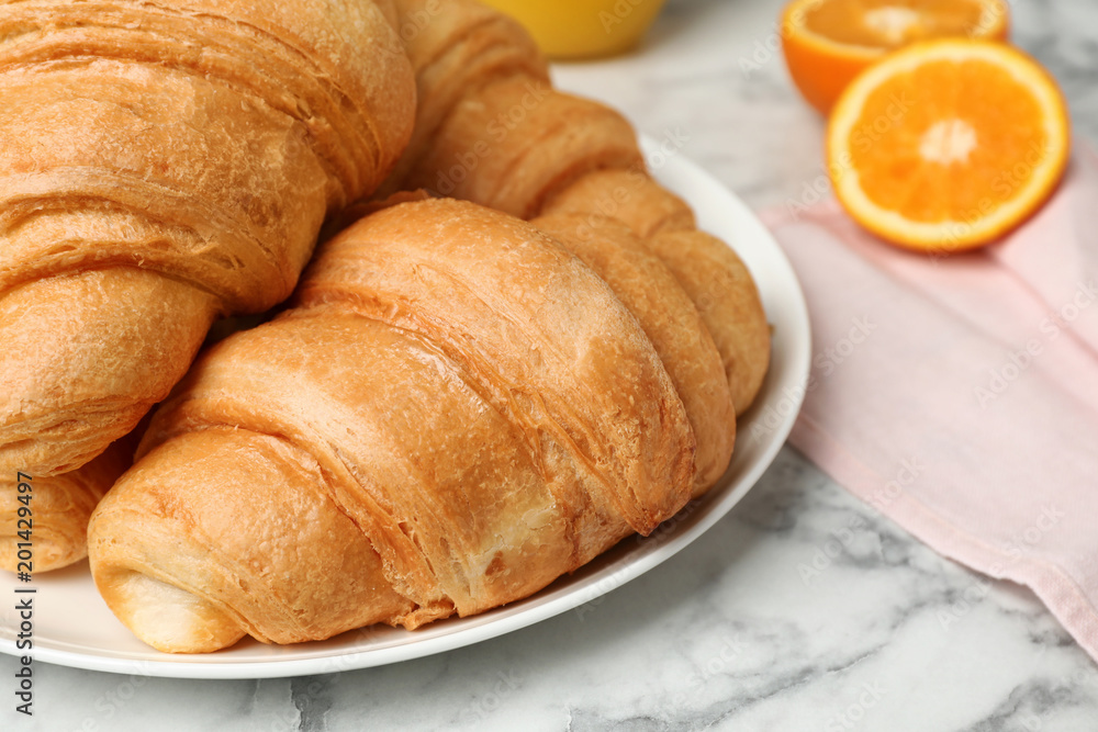 Tasty croissants on plate, closeup Tasty croissants on plate, closeup