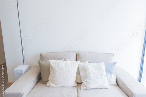 Sofa with colorful pillows in room photo
