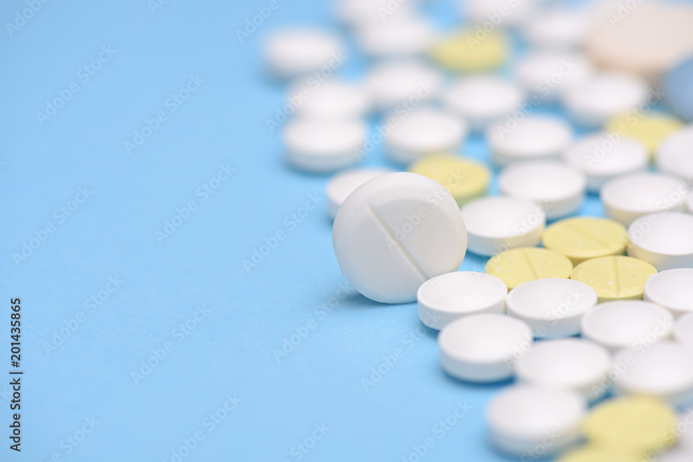 medicine tablets on blue background