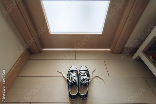 Фотография Sneakers with loosened laces. Take off your shoes. Etiquette