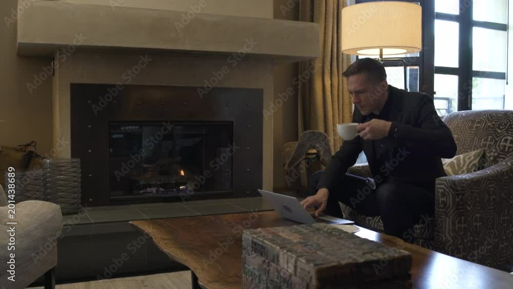 Young man using a laptop while sitting in a suite Young man using a laptop while sitting in a suite