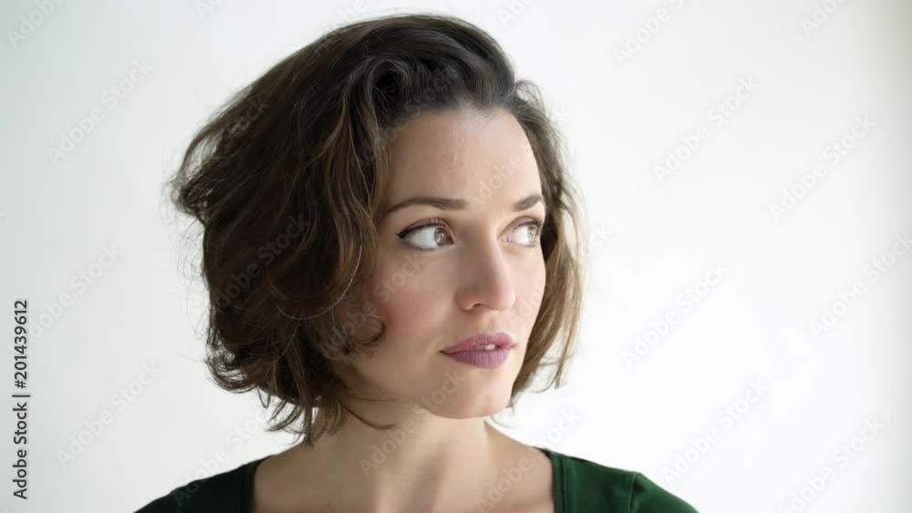 Mid adult woman facing camera and smiling, studio shot. Mid adult woman facing camera and smiling, studio shot.