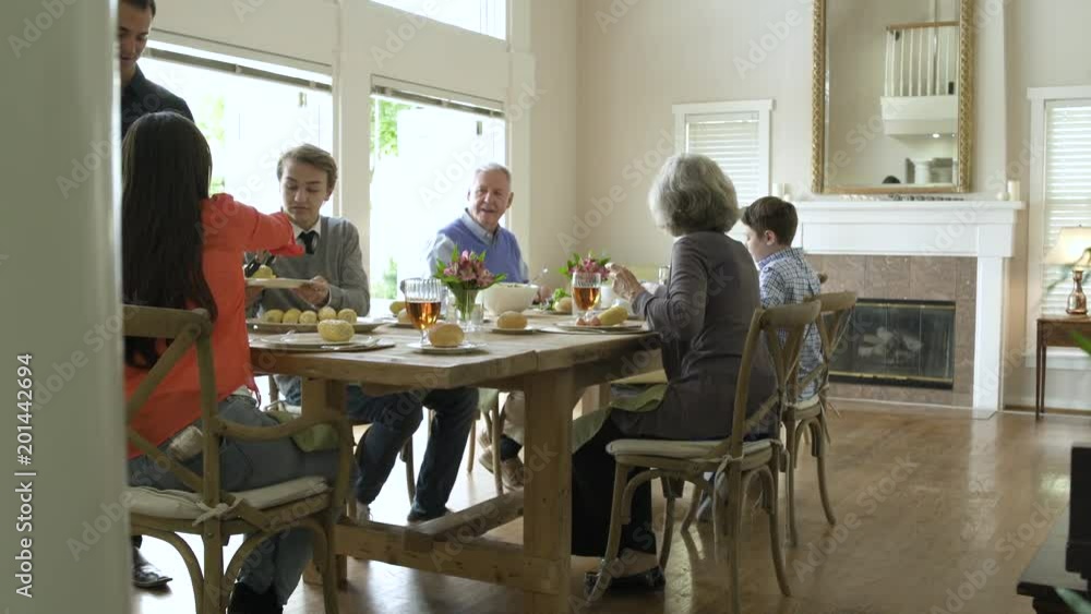 Family dining together at dining table. Family dining together at dining table.